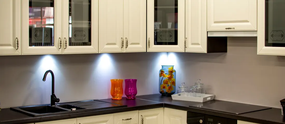 Kitchen with cream painted raised panel cabinets and a dark counter