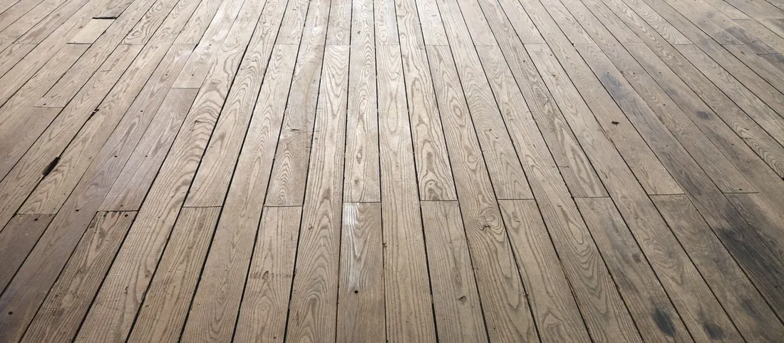 Wide plank wood floor sanded back to bare timber filling the frame